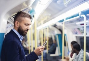 46625089 - young handsome businessman with smartphone in subway