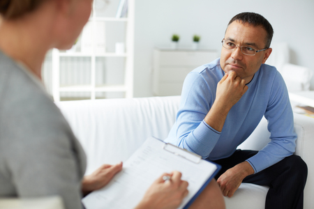 47055764 - pensive man in eyeglasses listening to psychologist