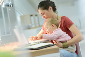 47107742 - woman working from home with baby on lap
