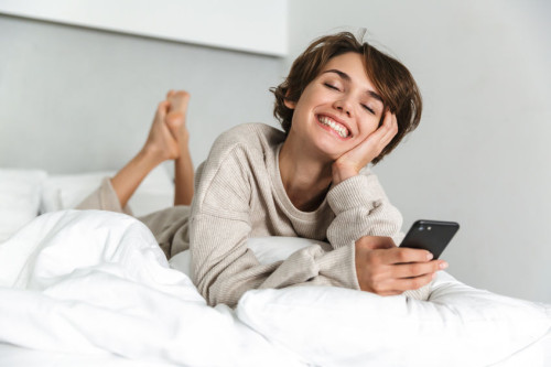 Smiling young girl relaxing in bed