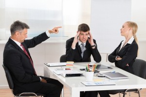 46636958 - mature businessman arguing with his two co-workers in office