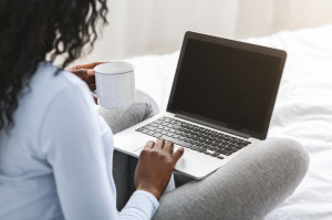 Back view of girl looking at blank laptop screen